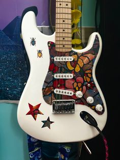 White stratocaster, white, custom guitar, custom pickgaurd, aesthetic, cool guitar , squier, fender, guitar stickers, pretty guitar, Electric Guitar Pretty, Acoustic Guitar Custom, Painting On Electric Guitar, Stratocaster Guitar Aesthetic, Decorated Guitars Stickers, Stickers On Guitar Acoustic, Electric Guitar Colors, Cool Guitars Electric, Electric Guitar With Stickers