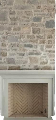 an empty fireplace in front of a stone wall with a brick chimney and white mantle