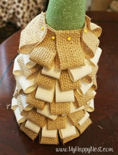 a vase made out of burlap and jute paper on a wooden table