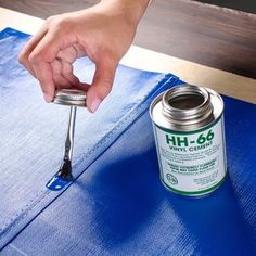 a person using a brush to paint a piece of furniture