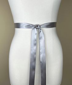 "Extra Narrow Silver Sash  Bright Silver Satin Sash Belt  Skinny Sash Belt, Thin Sash Belt  Skinny Silver Belt, Satin Silver Belt  Satin Swank  Up your style quotient with this extra narrow Satin Swank® waist sash.  Depending on your waist size and the length you choose, you can wrap this sash around your waist once or twice. You decide whether to tie the sash in a bow or a simple knot with long-hanging tails. Tie in front, in back, or on the side. Silky charmeuse satin fabric in bright, shimmery silver on both sides means there is no \"wrong side\" of the sash peeking through, resulting in the perfect finishing touch for your special occasion that you also can continue to mix into your wardrobe when your outfit needs just a little special something. Please note this is a fabric sash, hand Bridesmaid Sash, Wedding Dress Sash, Waist Sash, Silver Belt, Satin Sash, Dress Sash, Beautiful Belts, Silver Belts, Sash Belts