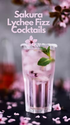 a glass filled with ice and pink flowers