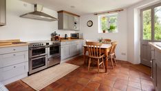 the kitchen is clean and ready to be used for cooking or dining, with tile flooring