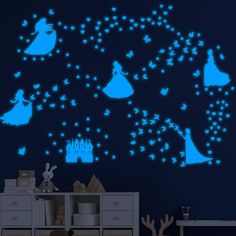 a child's room with blue walls and stars in the night sky, including silhouettes of princesses