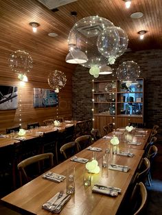 an empty dining room with balloons hanging from the ceiling and tables set up for dinner