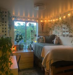 a bed room with a neatly made bed and lots of plants on the wall next to it