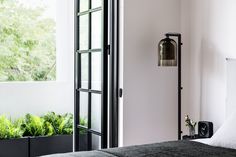 a bedroom with white walls and black furniture