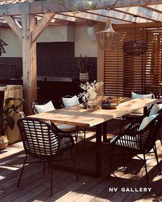 an outdoor table and chairs on a deck with the words nv gallery above it