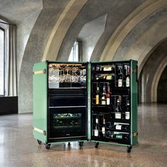 an open wine cooler sitting on top of a floor