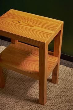 a small wooden table sitting on top of a carpeted floor