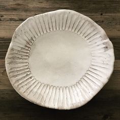 a white plate sitting on top of a wooden table