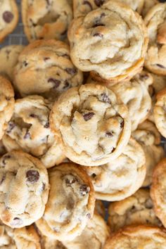 chocolate chip cookies piled on top of each other with one cookie in the middle surrounded by others