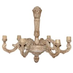 an ornate chandelier with four candles on it