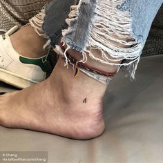 a person with a small tattoo on their ankle