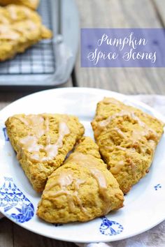 three scones are sitting on a blue and white plate