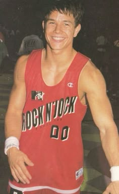 a young man in a red jersey is smiling