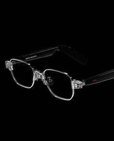 a pair of glasses with clear frames on a black background in the dark, it looks like they have been made out of plastic