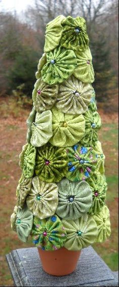 a potted plant made out of green fabric with flowers on the top and bottom