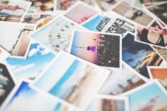 a pile of polaroid pictures with the word travel over them