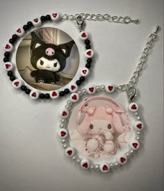 two key chains that have pictures of animals in them and hearts on them, one with a stuffed animal