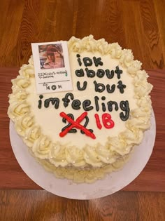 a cake that is sitting on top of a table with writing on the frosting