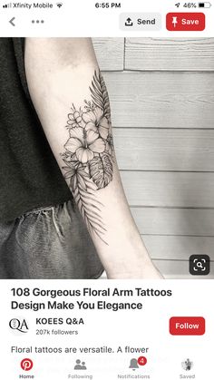 a black and white flower tattoo on the left arm, with palm leaves around it