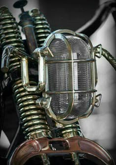 a close up view of the front end of a motorcycle with an old fashioned light on it