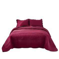 a bed covered in a maroon bedspread and pillow cases with two pillows on each side