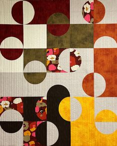 an abstract quilt with circles and flowers on it