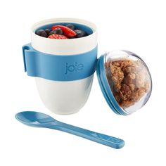 a blue and white bowl with cereal in it next to a plastic spoon on a white background