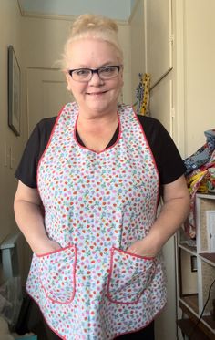 a woman with glasses is wearing an apron