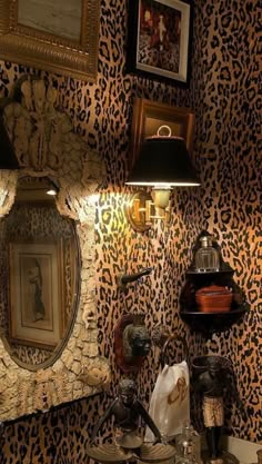 a bathroom with leopard print wallpaper and two lights on the side of the sink