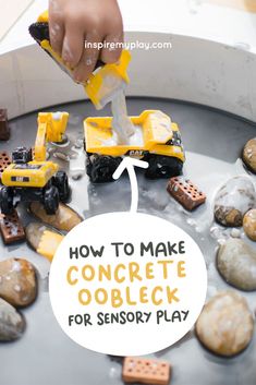 a child is playing with construction toys in a play table that has rocks and sand on it