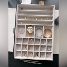 a white jewelry box filled with lots of different items