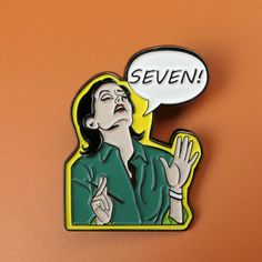 a woman with her hand up in the air and saying seven on it's back