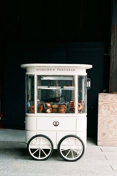 an old fashioned ice cream cart on the sidewalk