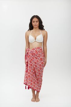 Crafted from lightweight cotton fabric, this sarong can be styled in multiple ways – wear it as a beach cover-up, a scarf, or a wrap skirt. The vibrant Aztec motif print adds a pop of color and pattern to your beach ensemble, making it a standout piece in your vacation wardrobe. Whether lounging by the pool or strolling along the shoreline, the Margot Sarong is the perfect companion for your next tropical getaway. Beachy Wrap Sarong For Beach Cover-up, Tropical Tie-side Sarong For Beach Cover-up, Beachwear Wrap Sarong For Poolside, Poolside Wrap Sarong Beachwear, Poolside Wrap Sarong For Beachwear, Beachwear Sarong With Tie-side For Beach Cover-up, Tie-side Beachwear Sarong, Bohemian Sarong With Tropical Print For Beach Season, Summer Beach Sarong With Vibrant Print