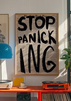 a poster that says stop panck ing on the side of a table next to a lamp