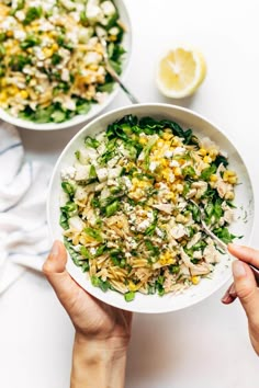 two bowls filled with salad next to each other on top of a white countertop