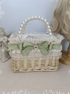 a white wicker basket with a green bow