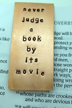 a bookmark that says never judge a book by its movie