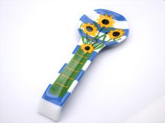 a blue and white toothbrush with sunflowers on it