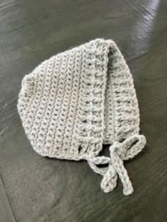 This handcrafted crochet bonnet for baby is an adorable way to accessorize!   The bonnet is made with 100% Baby Alpaca Wool and is very soft for your baby's comfort.   Machine wash, no bleach, lay flat to dry. Cute Crochet Bonnet Made Of Yarn, Cute Crochet Yarn Bonnet, Handmade Adjustable Yarn Bonnet, Cute Crochet Bonnet, Adjustable Crochet Yarn Bonnet, Adjustable Handmade Gray Crochet Hat, Handmade Adjustable Gray Crochet Hat, Crochet Bonnet, Baby Bonnet