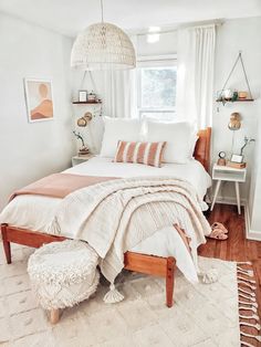 a bedroom with white walls and wooden floors