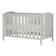 a baby crib with white bedding and pillows on the bottom half, in front of a white background