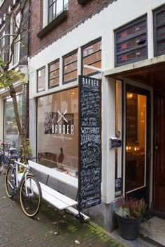 an outside view of a restaurant with bikes parked on the sidewalk