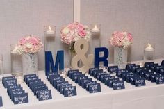 the table is set up with flowers and candles for an mr and mrs wedding reception