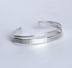 Silver Bracelet - Roller-printed and hammered texture brings unique, wave-like patterns to this split sterling silver cuff bracelet. Each is unique and will vary slightly.<br><br><b>Dimensions: </b><br>Small: 5.5L<br>Medium: 6L<br>Large: 6.5L Handmade Sterling Silver Cuff Bracelets, Silver Bangle Bracelets Unique, Soldering Jewelry, Artful Home, Sterling Silver Cuff Bracelet, Silver Bangle Bracelets, Sterling Silver Cuff, Silver Cuff Bracelet, Jewelry Inspo