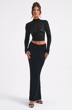 There's a sense of romance in the Fernanda skirt, crafted in beautiful stretch lace with a mesh lining for ultimate comfort. Fitting the body like a second skin, this sensual design features a floor sweeping maxi length. Pair with the Fernanda top and platform heels for drama. 



Colour: Black.

Premium stretch lace.

Lined in mesh.

Slightly lower waist fit.

Body hugging fit.

Maxi length.


Please note:: Model is wearing the Astrid Maxi Skirt underneath.

Model is an XS and is wearing an XS. Black Lace Maxi Skirt Outfit, Sheer Lace Maxi Skirt, Spring Black Lace Maxi Skirt, Spring Sheer Black Maxi Skirt, Black Lace Maxi Skirt, Homecoming Dresses Corset, White Dress Spring, Midi Dress Wedding Guest, Long Sleeve Homecoming Dresses