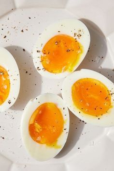 four hard boiled eggs on a white plate